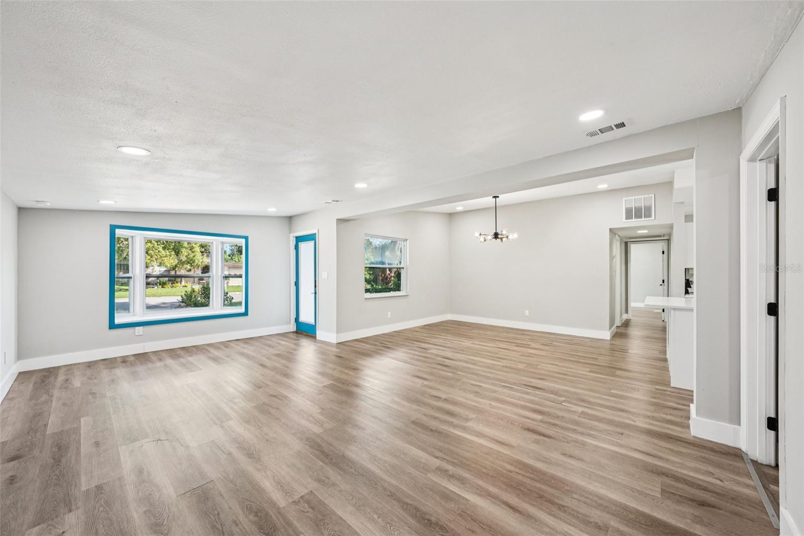 Open concept Kitchen, dining and living room with recessed lighting