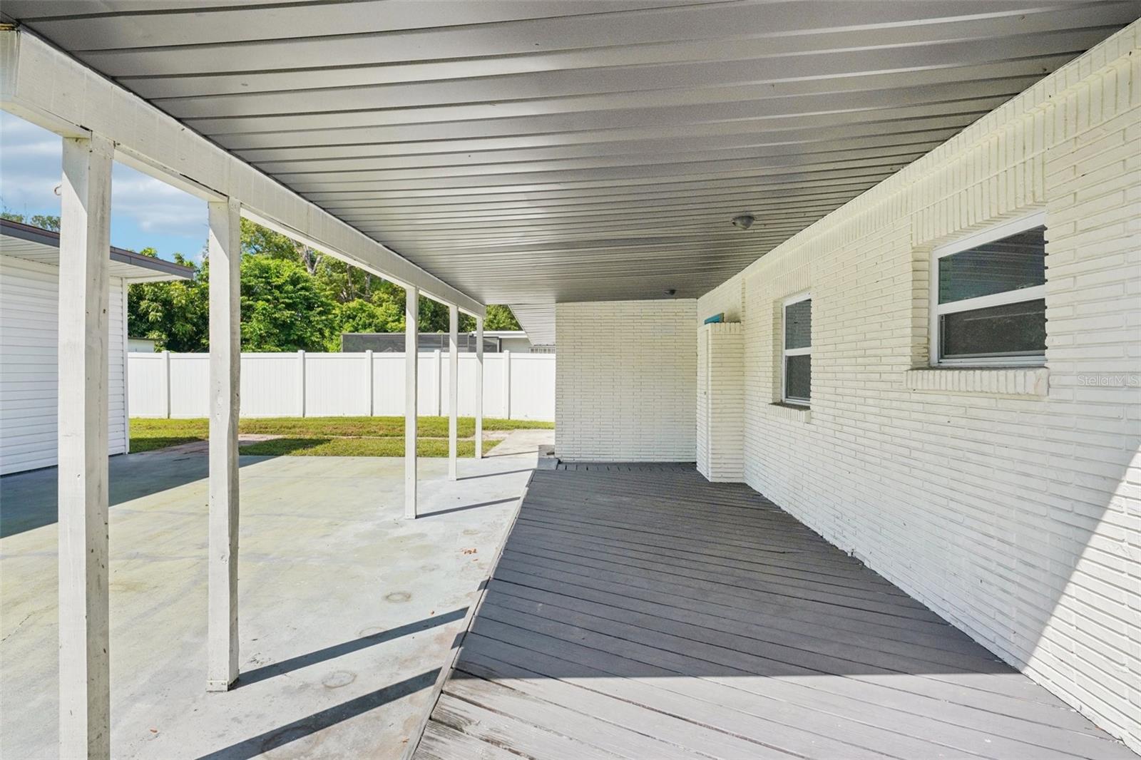 Out back, a covered deck extends the living space of the main house, ideal for outdoor dining, entertaining, or relaxing in the shade. The large backyard offers plenty of room for play, gardening, or future customization, while the connection between the main home and guest house enhances the property’s versatility.