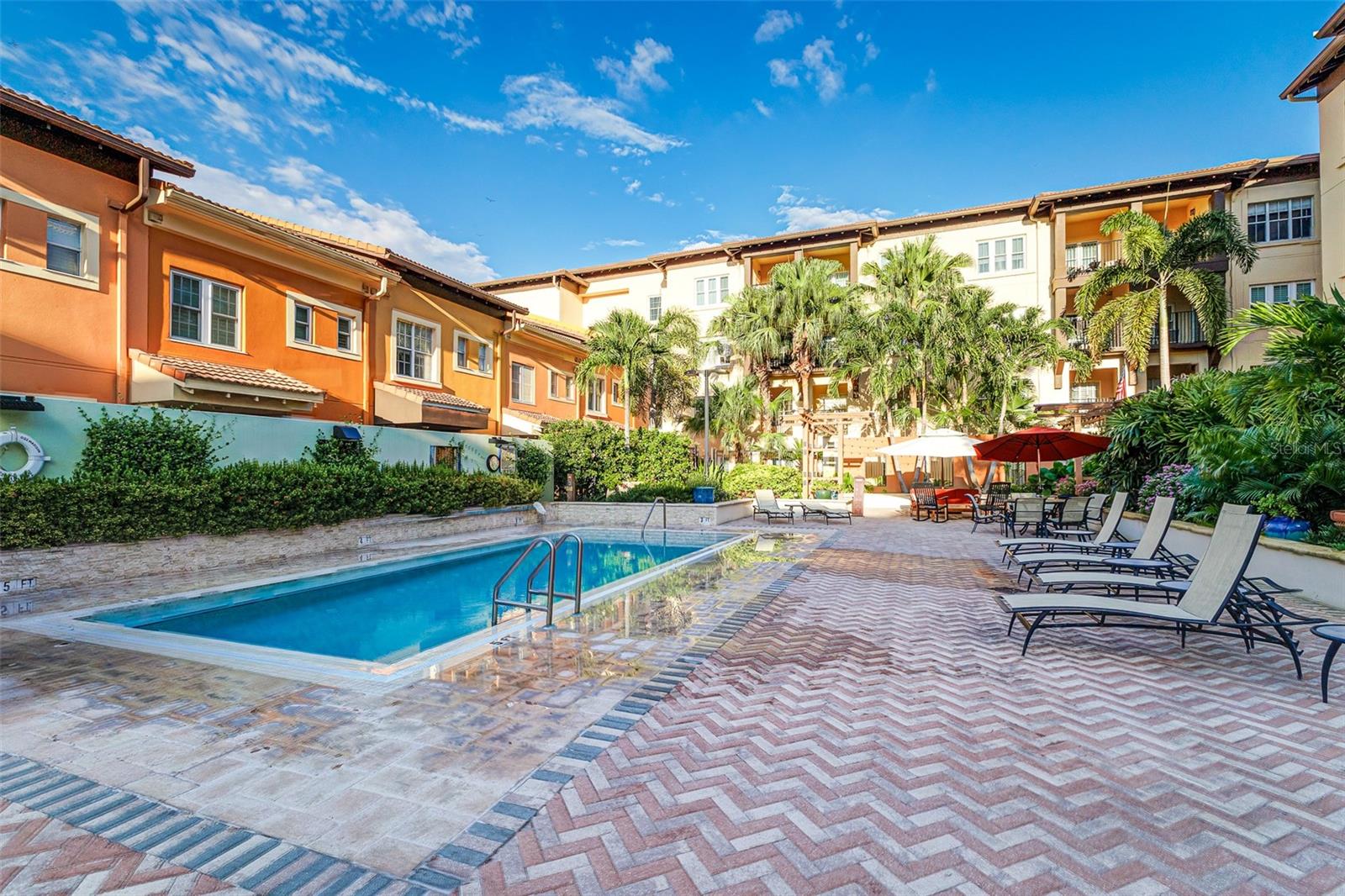 Courtyard view of heated pool and decking