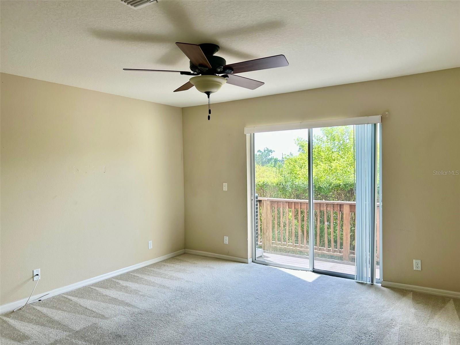 Great Room With Sliders Leading To Deck