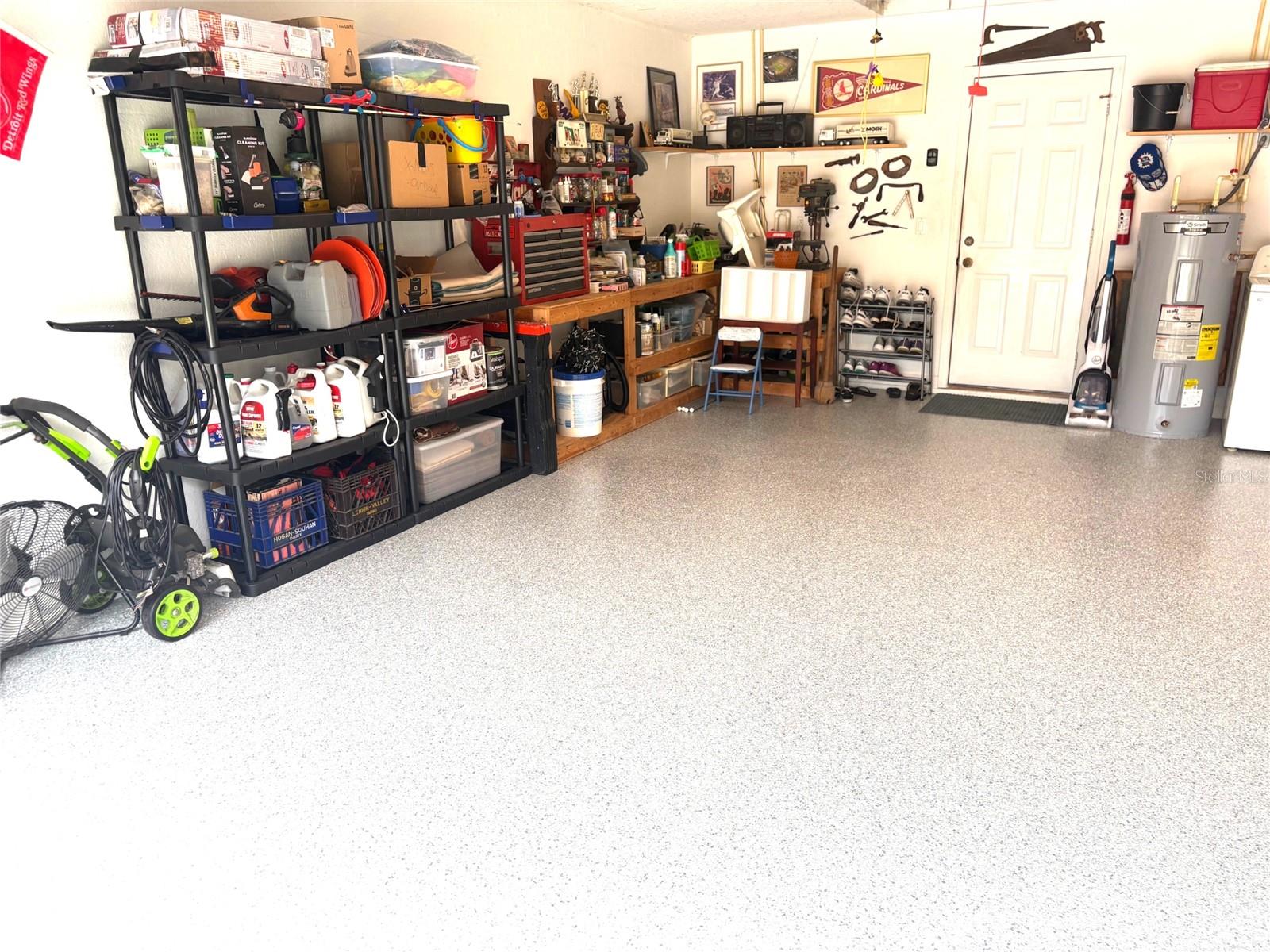 Garage with epoxy floors and wooden work table