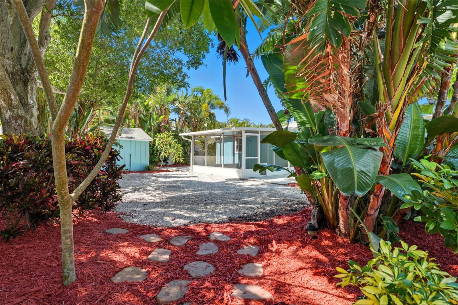 Large outdoor space surrounded by tropical greenery, perfect for entertaining or relaxing.