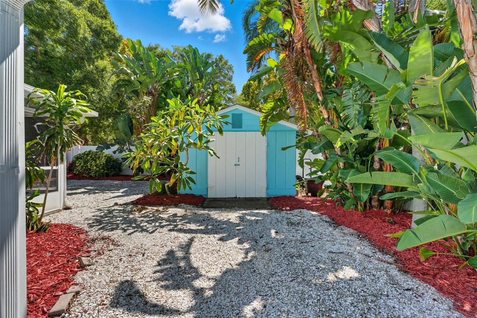 A matching storage shed with electrical power provides space for tools, bikes, or beach gear.