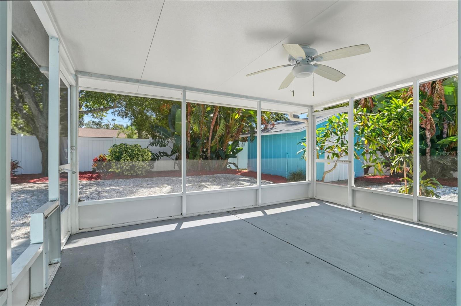 Step out from the home into a screened patio overlooking the backyard oasis.