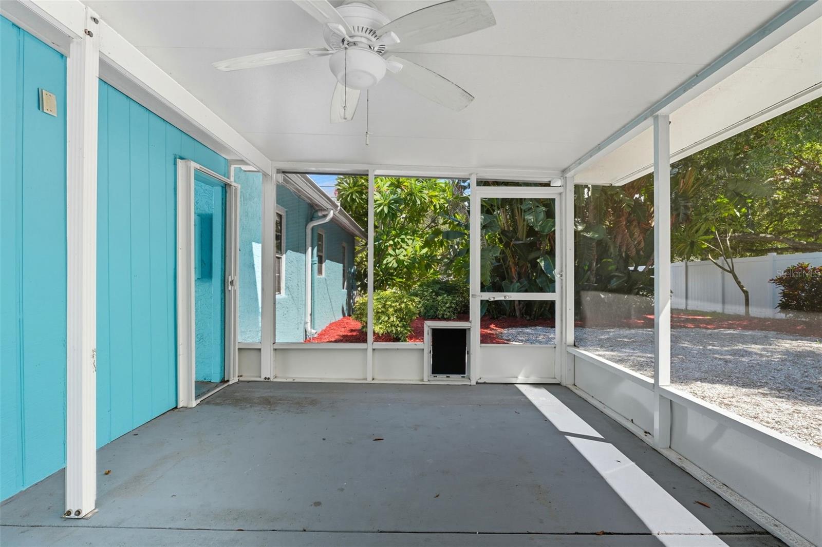 A comfortable screened retreat overlooking the landscaped backyard, ideal for relaxing year-round.