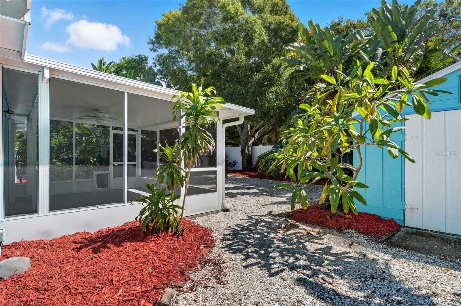 Charming stone path leading to the screened patio and backyard entertaining area.