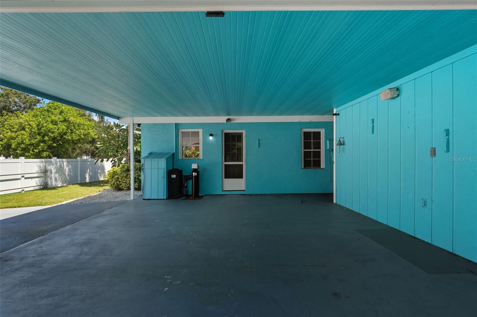 Versatile covered area that doubles as shaded outdoor space or protected parking.