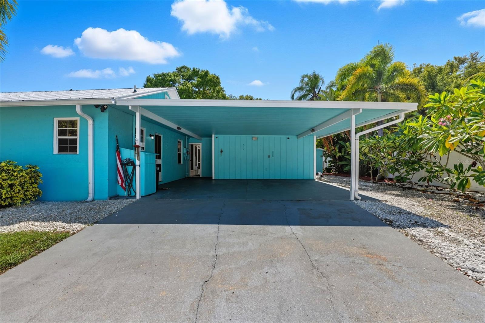 Expansive covered carport with plenty of space for multiple vehicles, boats, or golf carts.