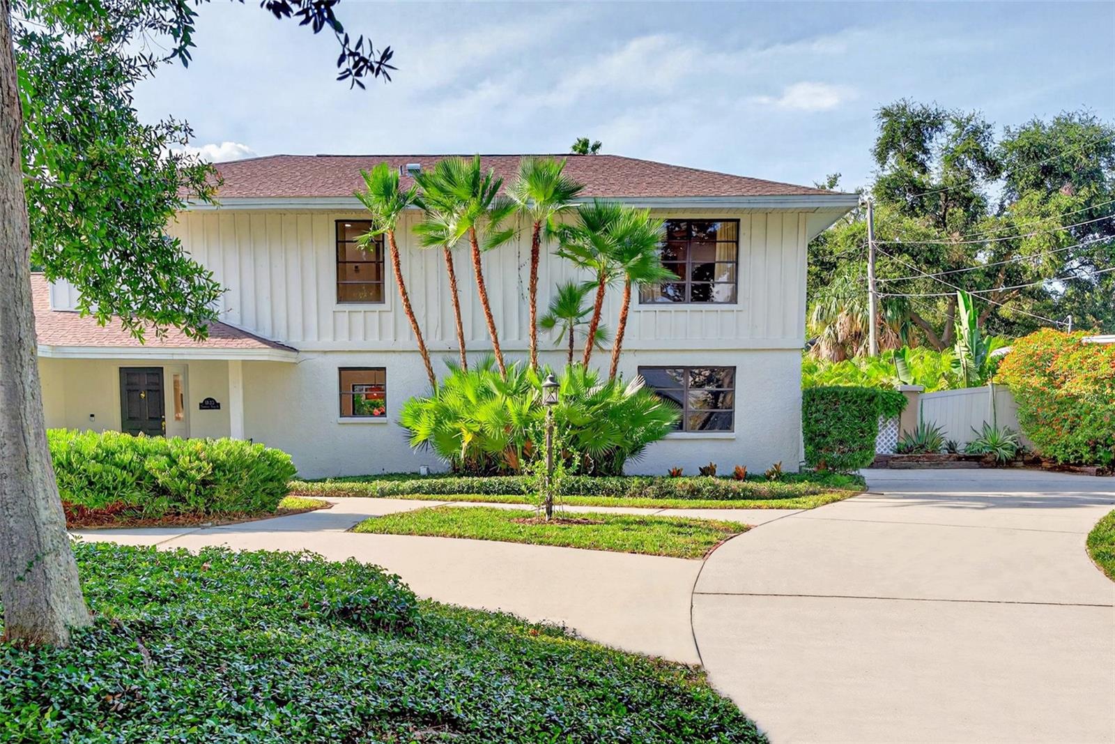 Lush florida landscaping. Large driveway on an oversized lot.