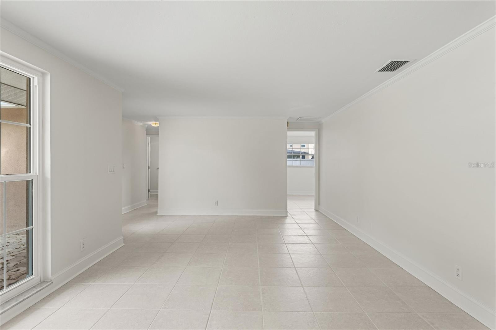 The open layout allows for flexible furniture arrangements and an easy flow toward the kitchen and bedrooms.