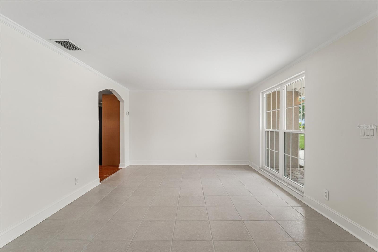 Double windows showcase the landscaped front yard while highlighting the home’s spacious, open design.
