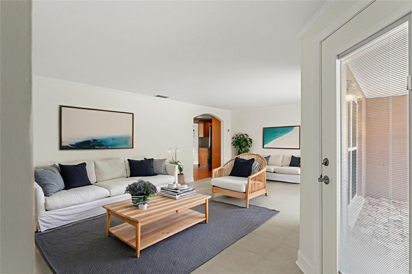 Spacious and open, this living room offers flexibility for entertaining or relaxing, with room for multiple seating areas and a seamless flow toward the kitchen.