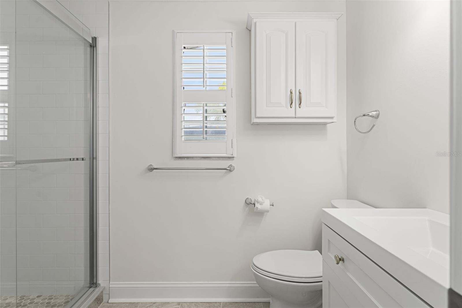 Updated with a step-in shower, modern fixtures, and plantation shutters for natural light and privacy.