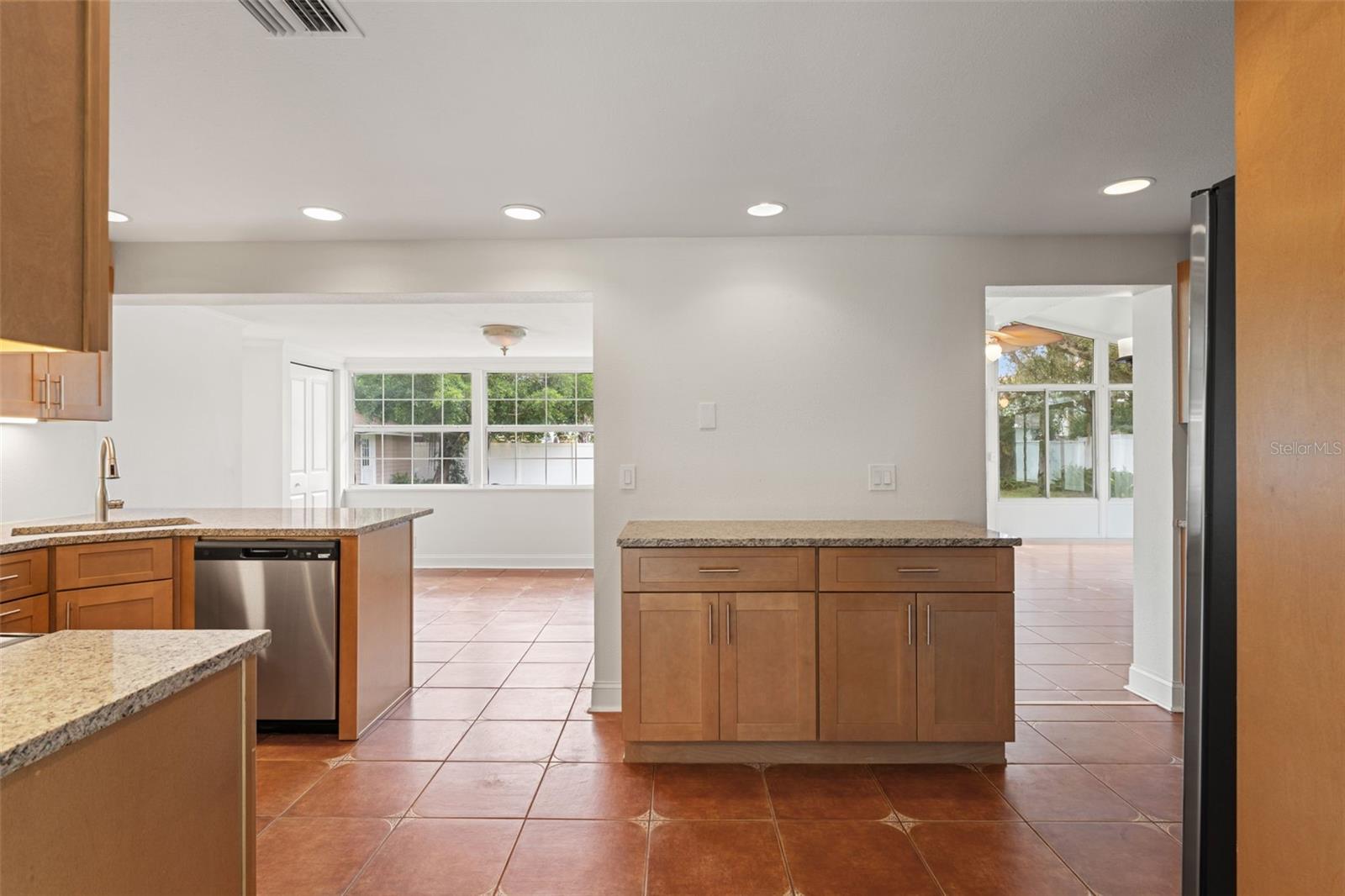Beautifully updated kitchen featuring solid wood cabinetry, granite countertops, stainless steel appliances, and recessed lighting.