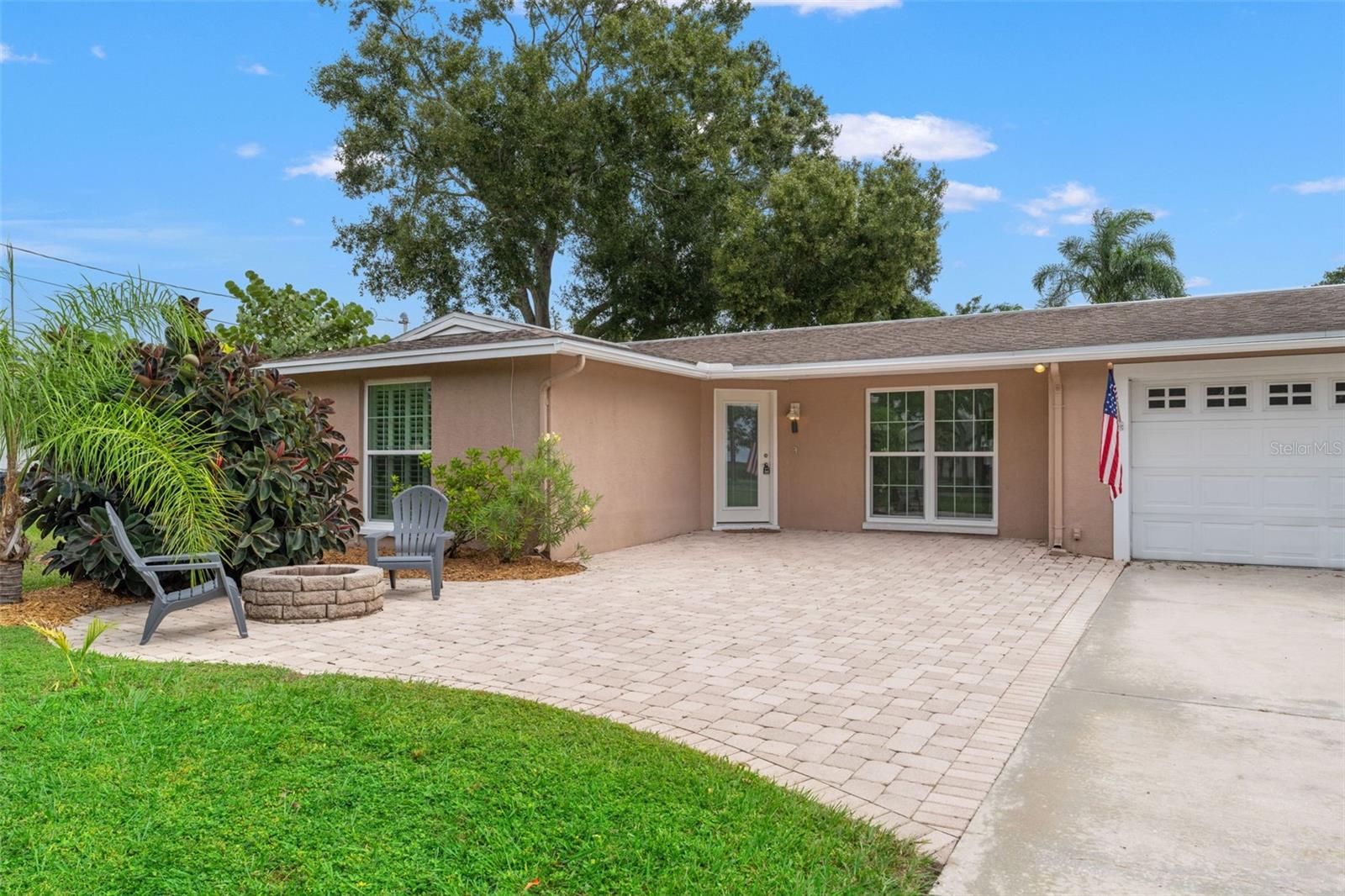 Enjoy relaxing evenings or morning coffee by the fire pit in this inviting front courtyard — the perfect extension of your living space.