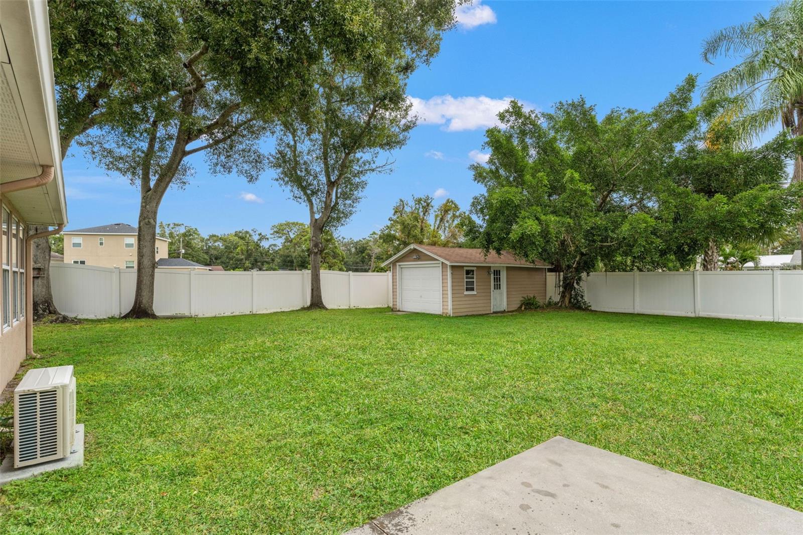 Expansive, fully fenced backyard with mature shade trees and a large workshop/storage shed complete with power.
