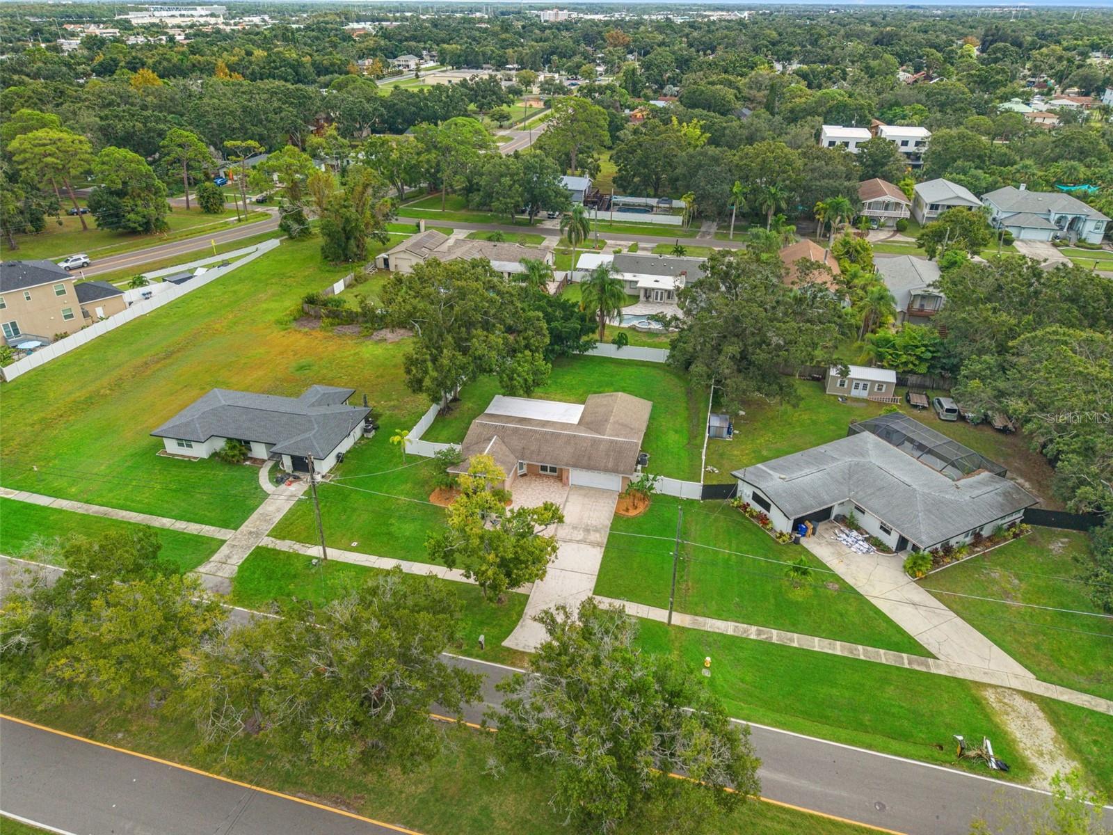 Oversized 100x150 lot tucked along a quiet, divided city street in the heart of downtown Oldsmar, surrounded by mature trees and well-kept homes.