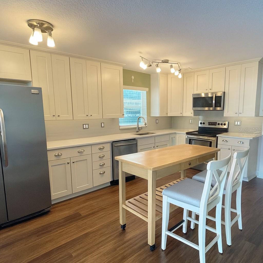 kitchen virtually staged with portable island and seating