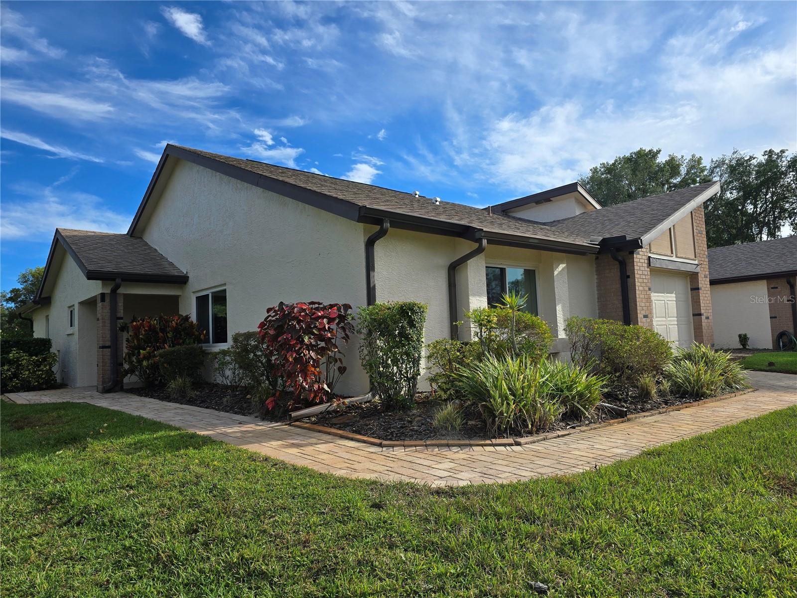 FRONT/SIDE EXTERIOR OF THIS BEAYTIFUL END UNIT VILLA