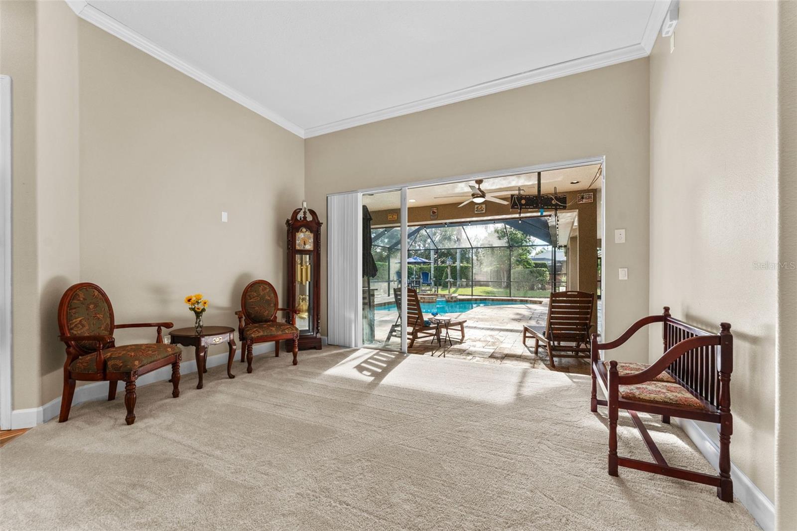 Formal Living Room Area with Triple Sliders to Pool