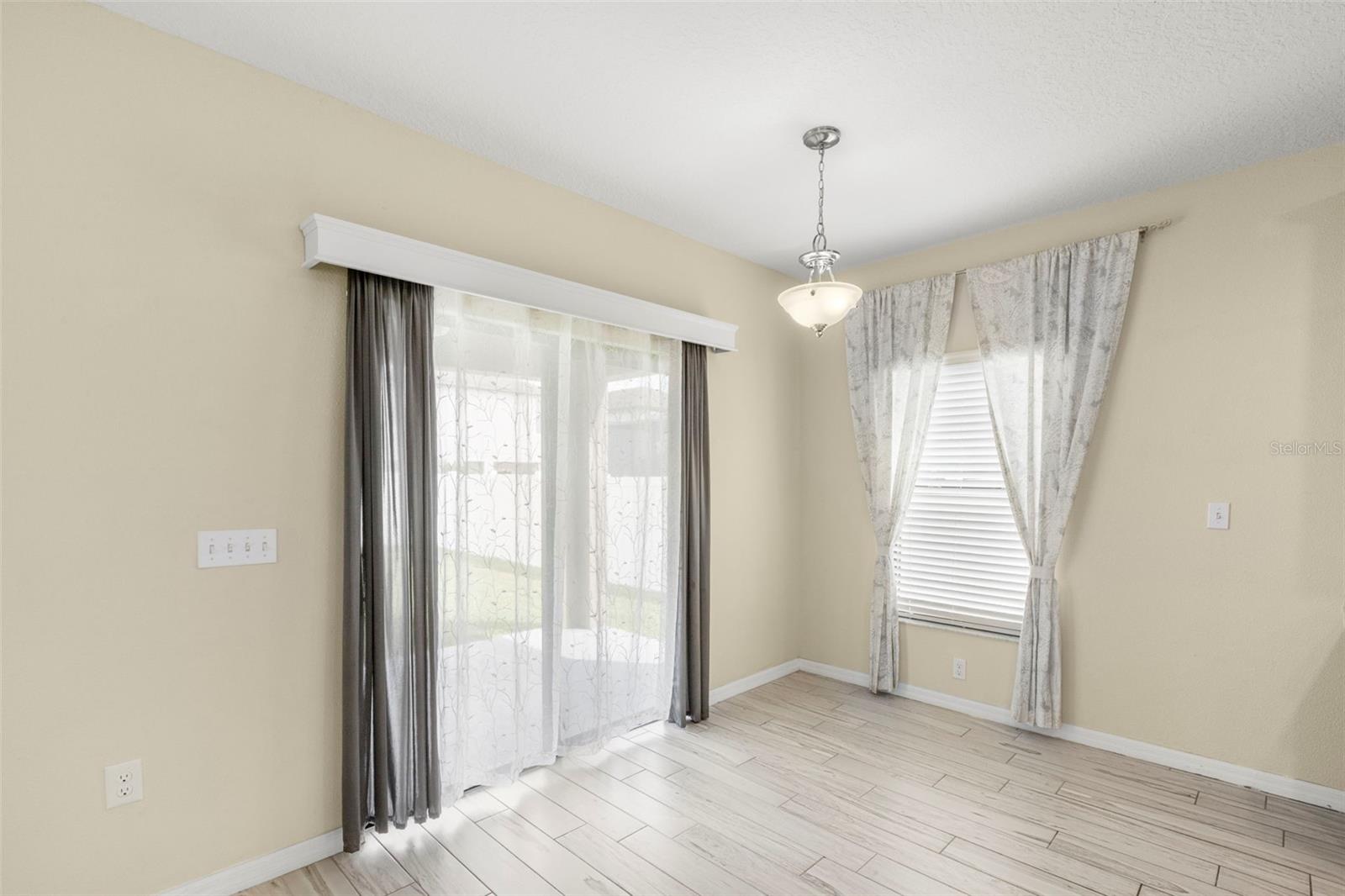 Breakfast nook off the kitchen with sliders to the covered lanai.