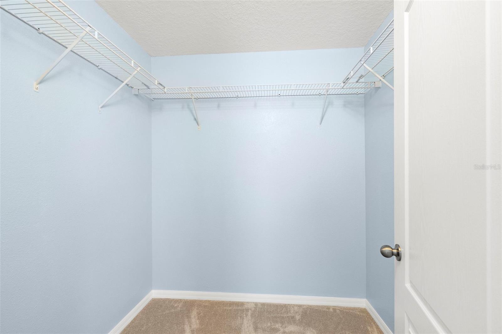 Primary bedroom walk-in closet