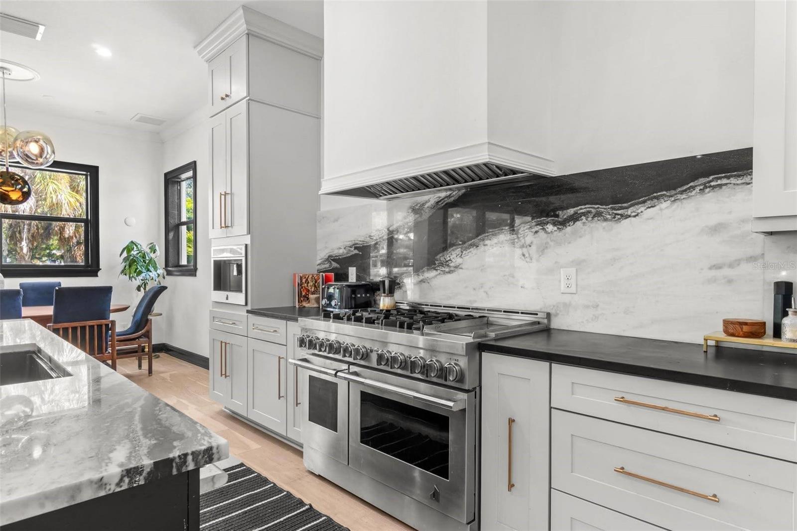 Panda Marble backsplash and Jenn-Air top of the line appliances.