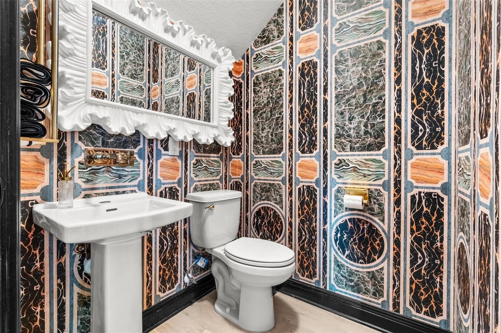Powder Room with Gucci designer wall paper.