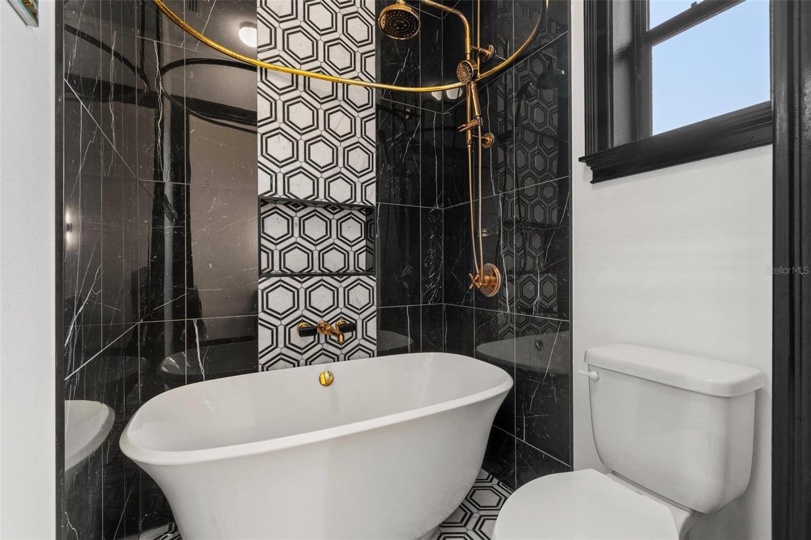 Bathroom 3 Tub/Shower Combo with Marble Accent Wall.