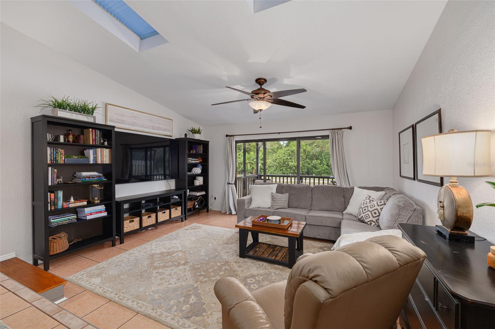 Living Room with Ceiling Fan & Skylights