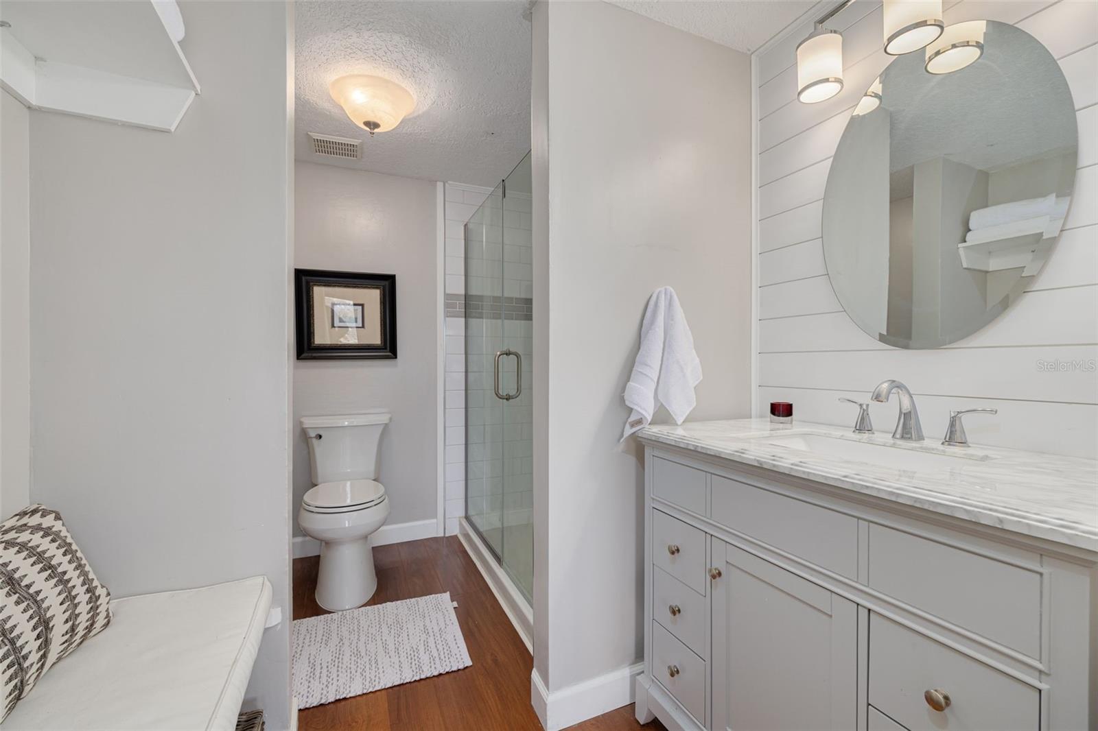 En Suite Primary Bathroom with Glass Shower, Built in bench and Shelving