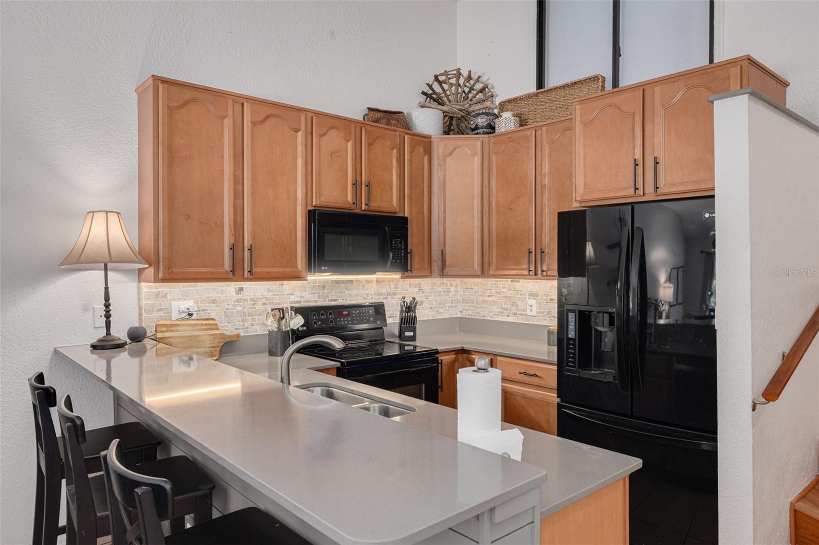 Kitchen with Quartz counters and Breakfast Bar