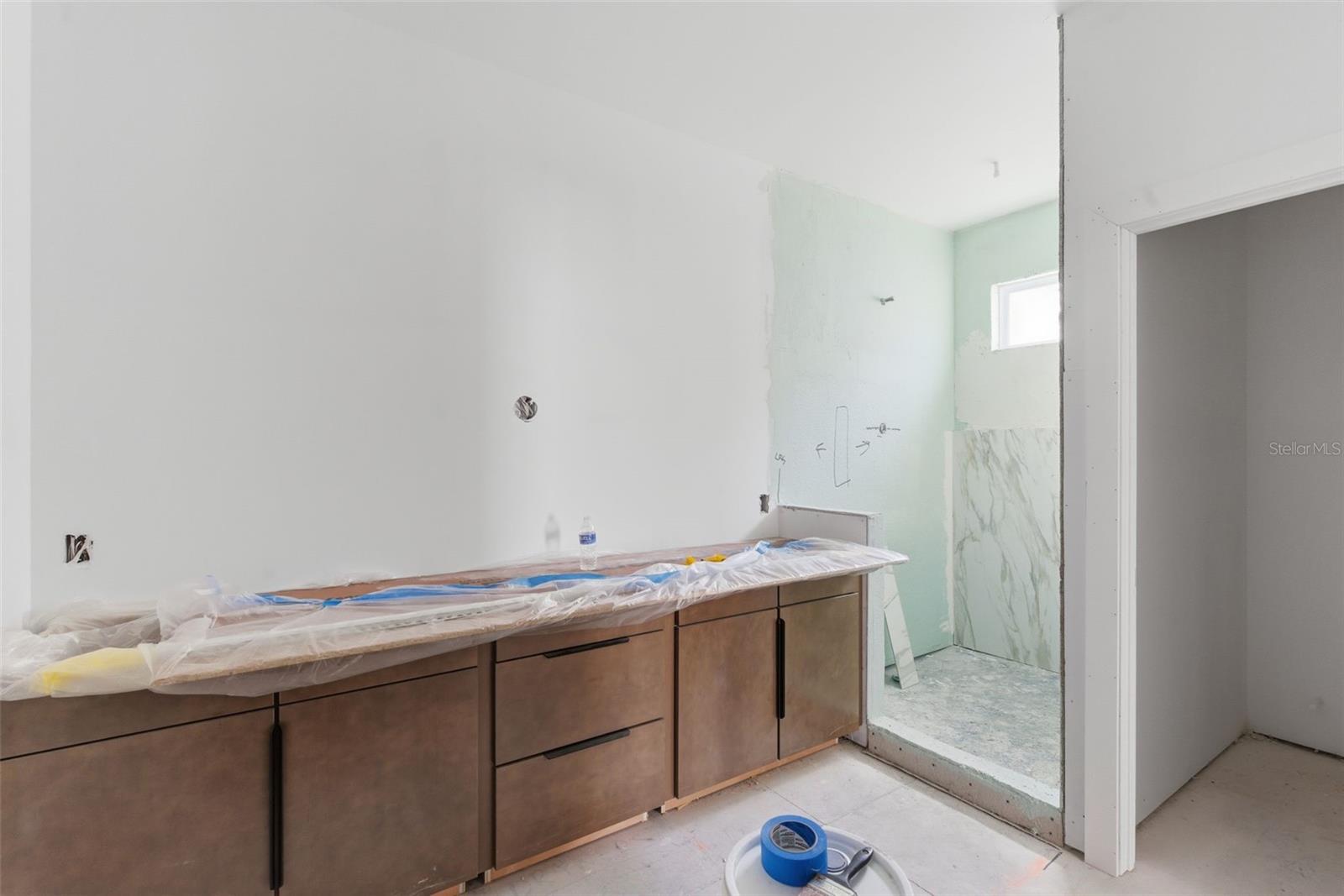 Primary Bath with standalone soaking tub and watercloset