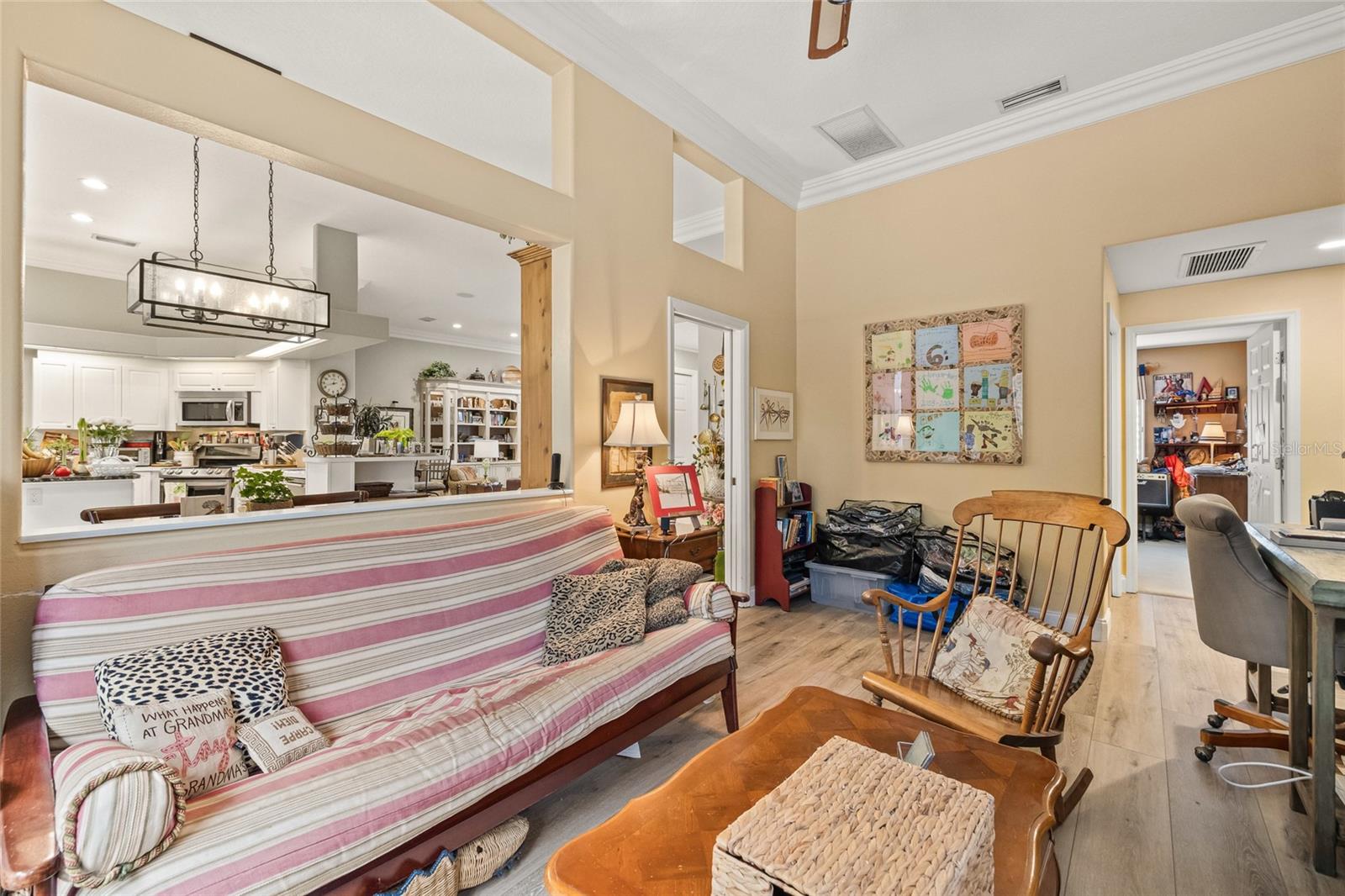 Bonus room with a pocket door and visibility to the kitchen and living room.