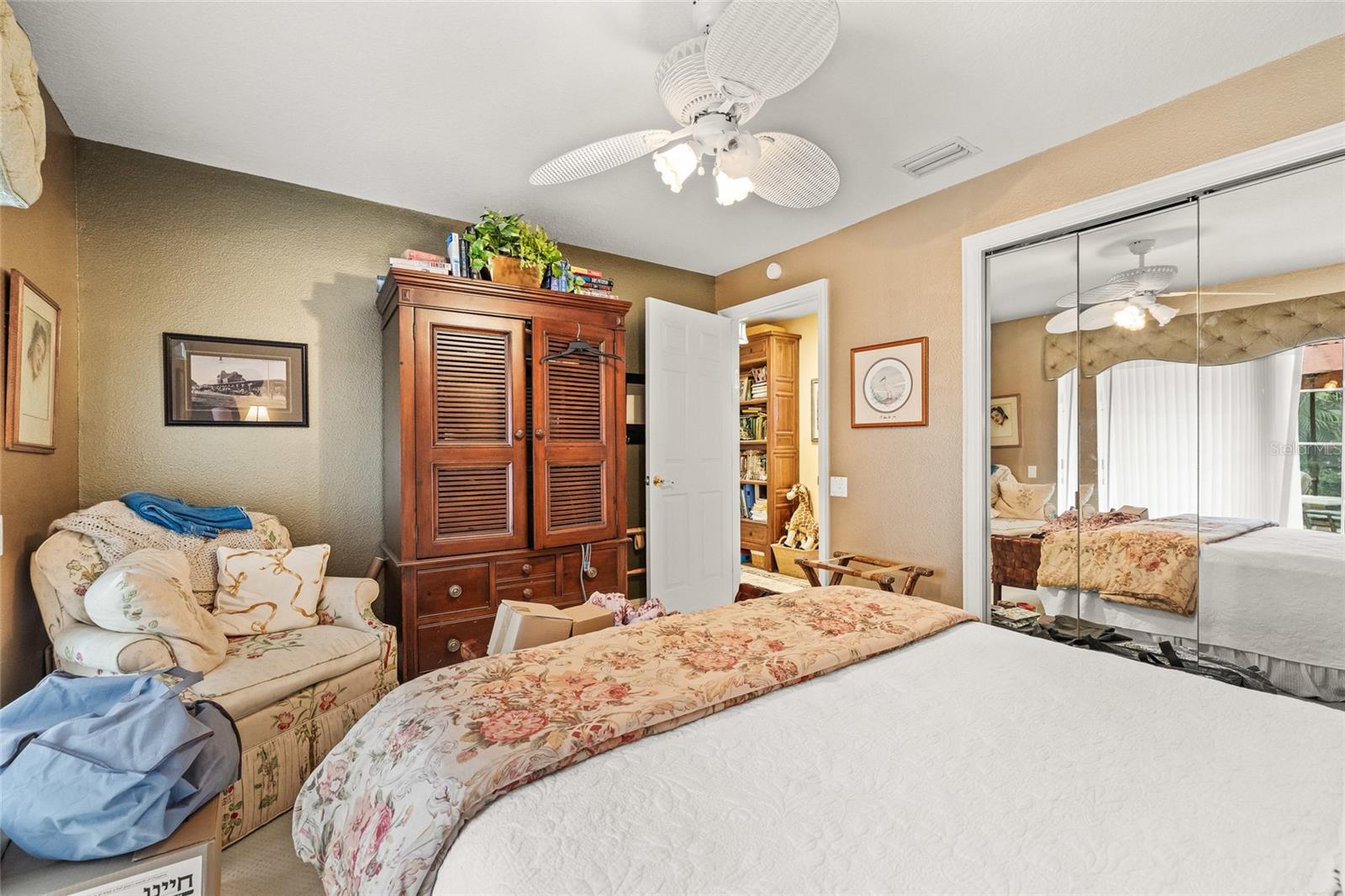 Guest bedroom with sliding glass door to the pool.