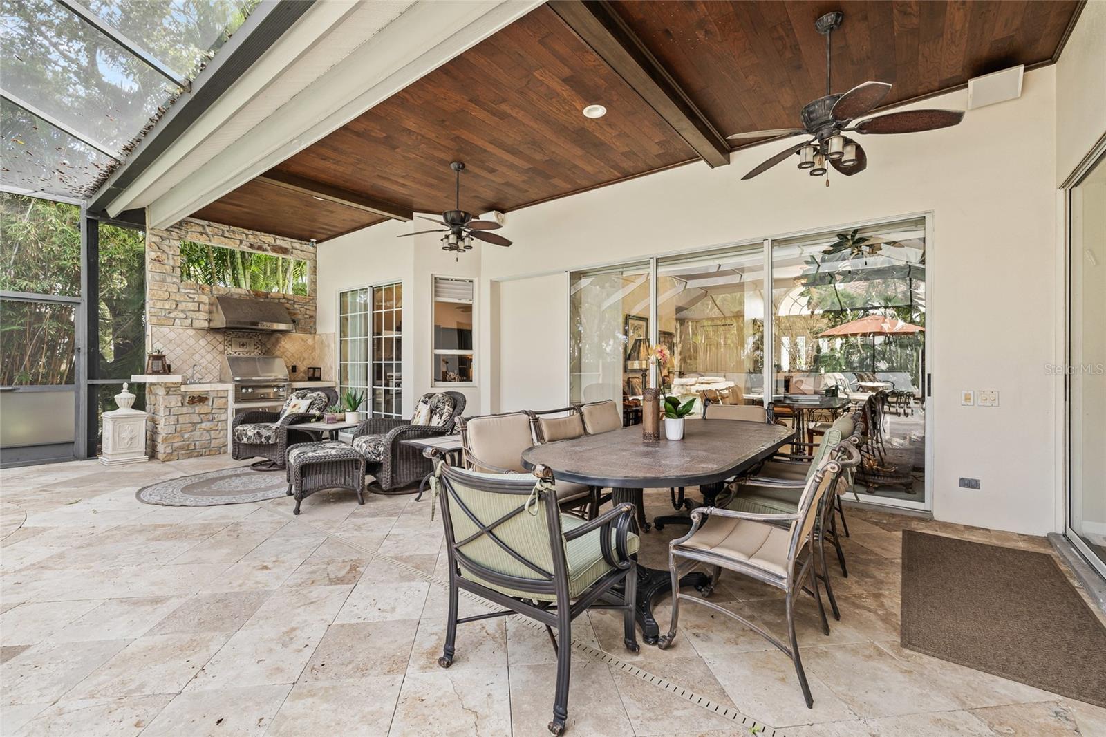 Outdoor perfection with an outdoor kitchen and topped off with a custom tongue and groove accent ceiling.