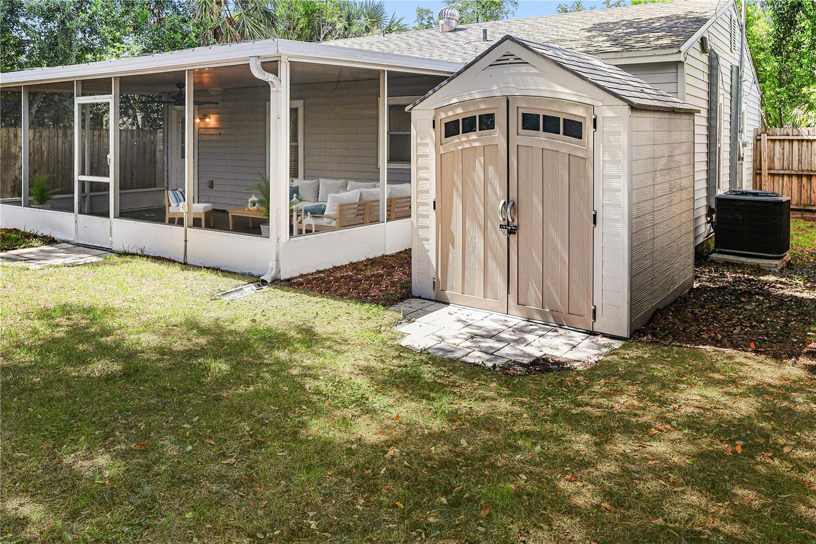 Relax on the screened patio while enjoying the private fenced yard and bonus storage.