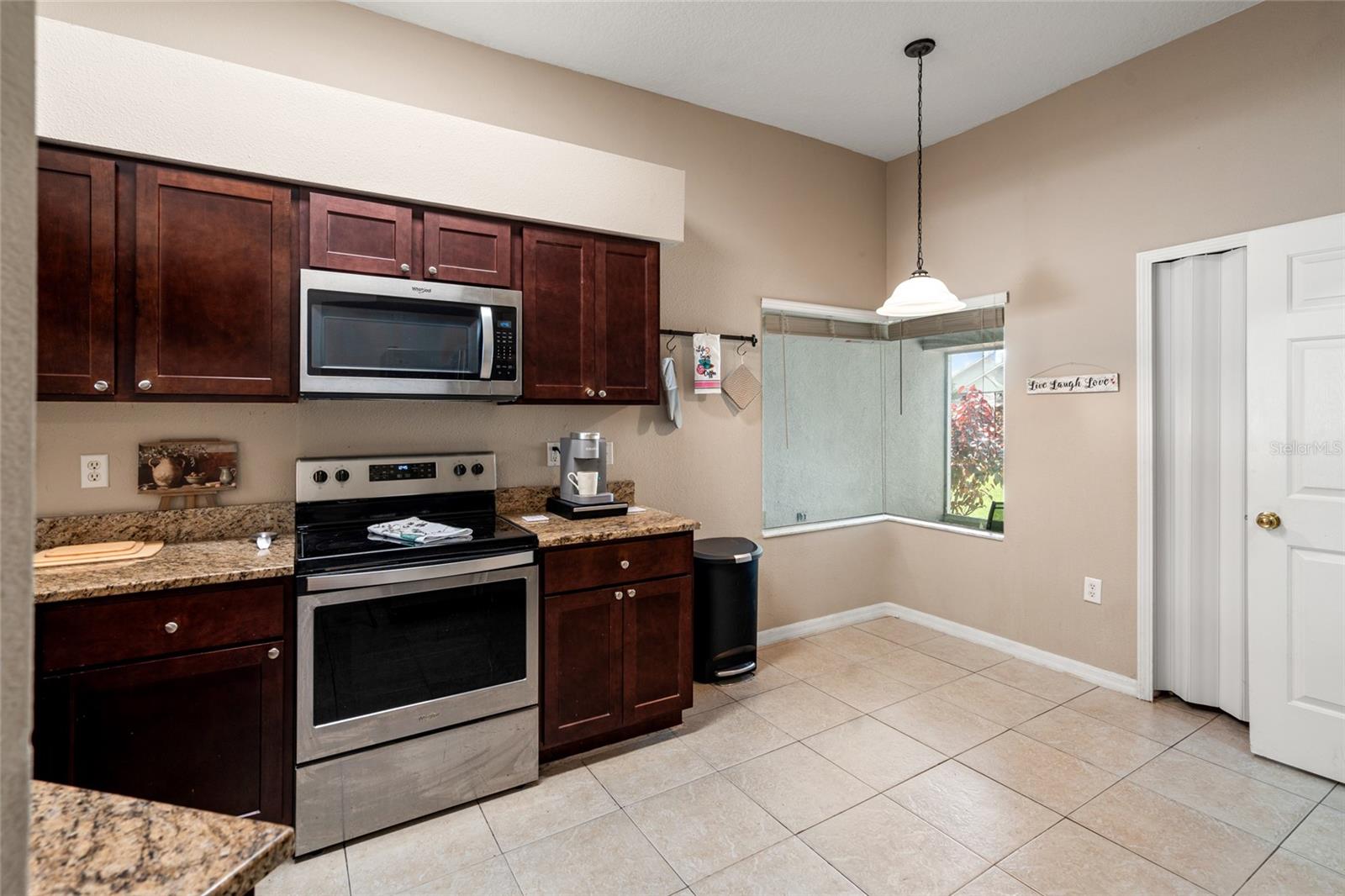 beautiful rich cabinets, stainless appliances, granite counter tops and eat-in bistro area as well as a pantry!