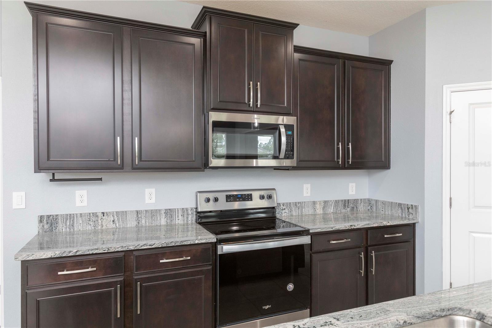 Wood Cabinets, Island Breakfast Bar, Stainless Appliances