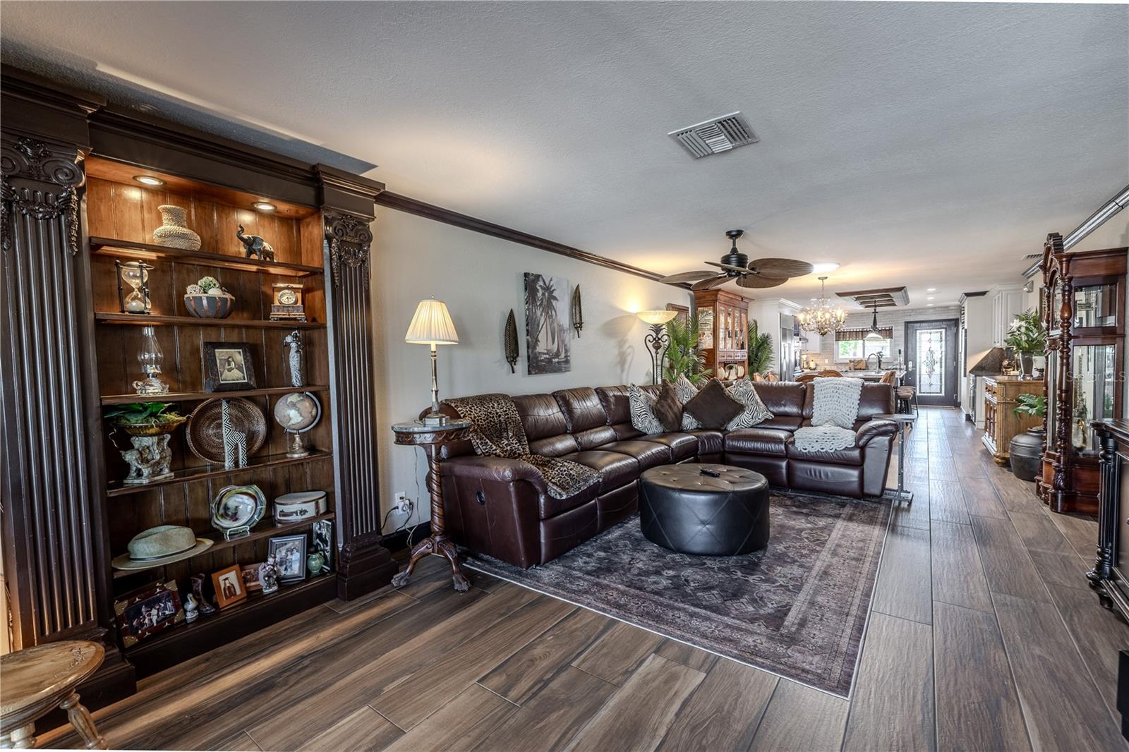 The living room offers recessed lighting, crown molding, and wide sliders that fill the space with natural light and canal views.