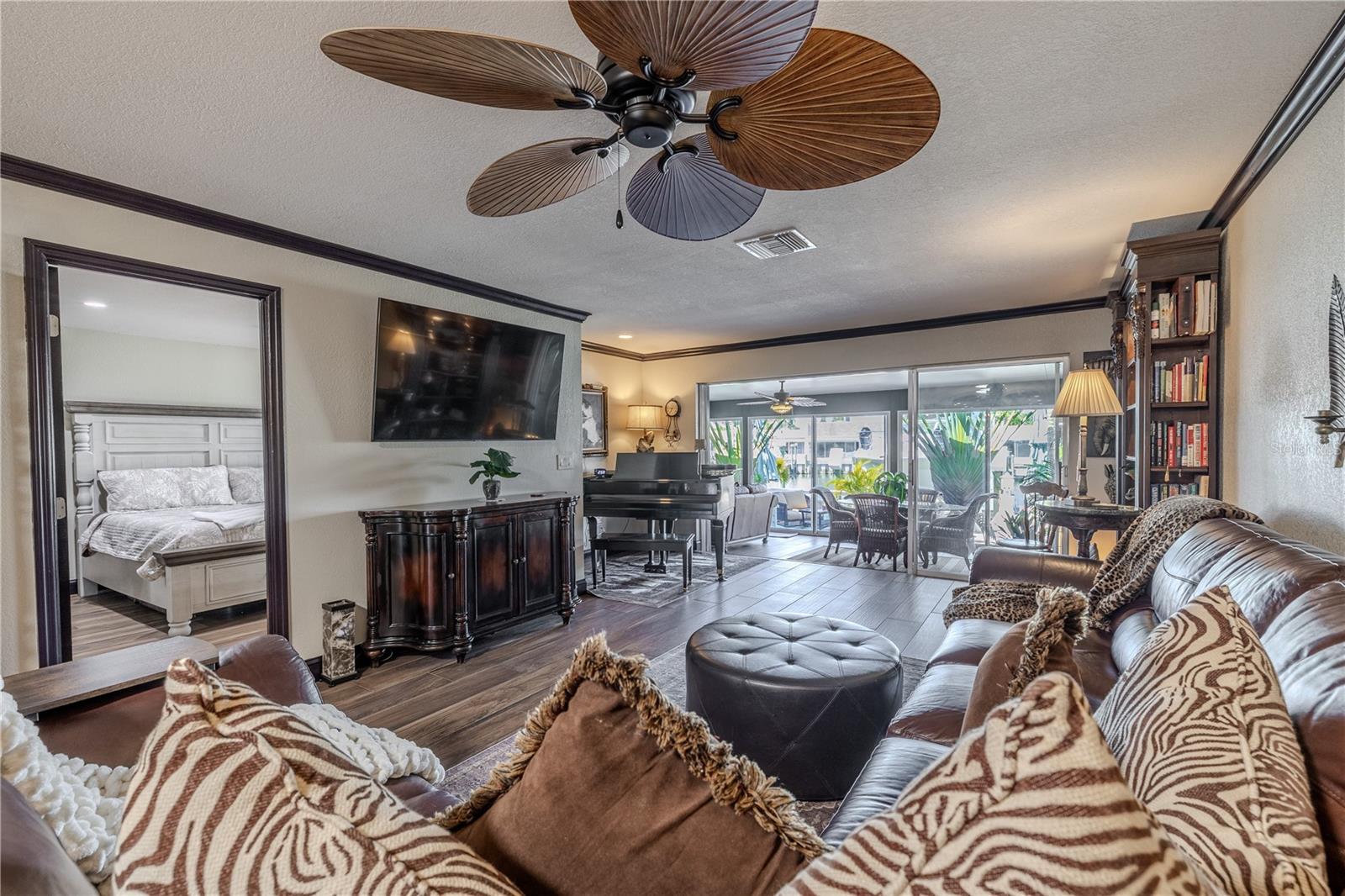 Multiple seating areas in the living room offer flexibility and function, all oriented toward the home’s beautiful waterfront backdrop.