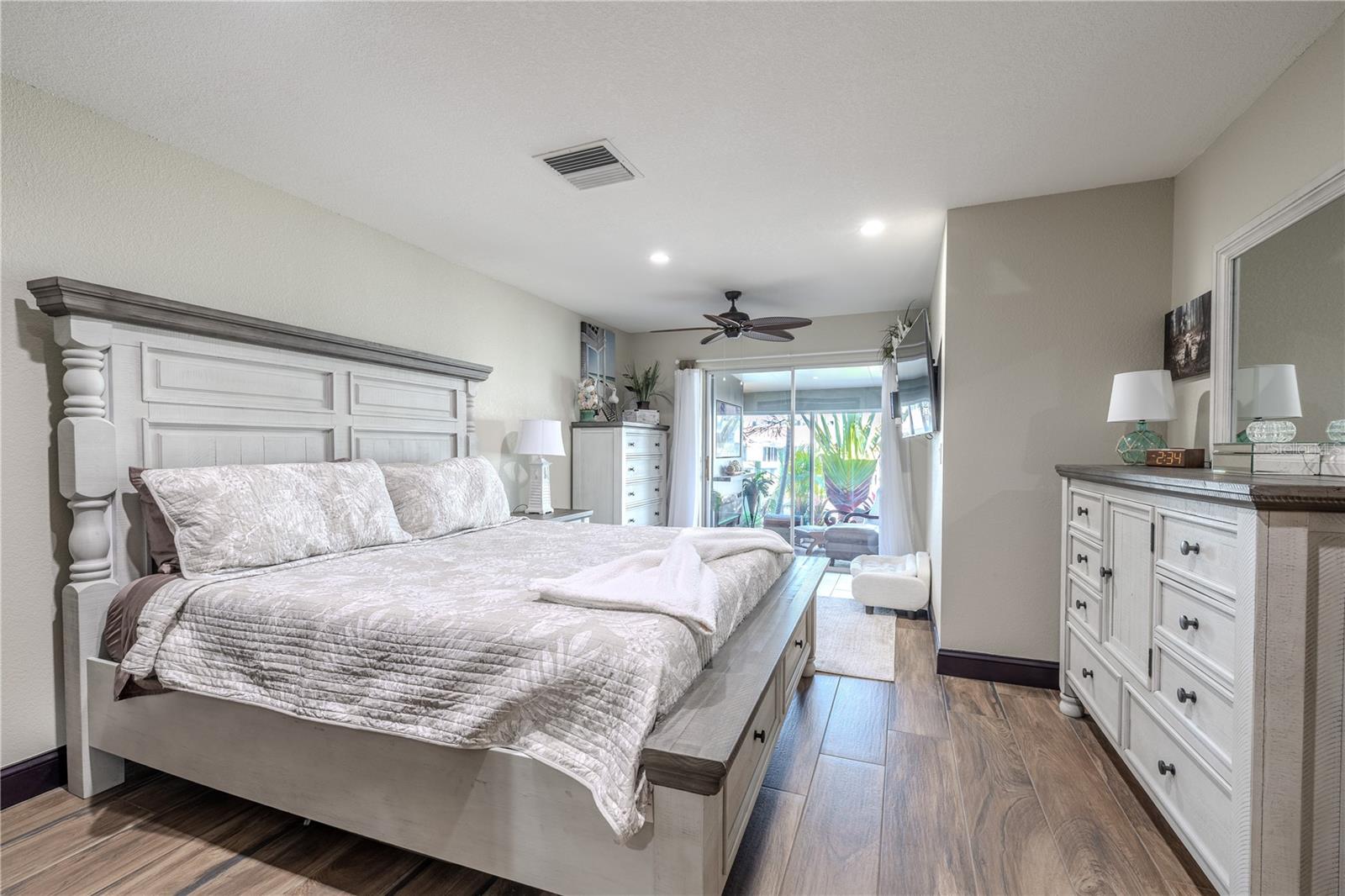 Designed for both comfort and function, the primary suite includes two closets with one featuring custom built-in shelving that maximizes storage space.