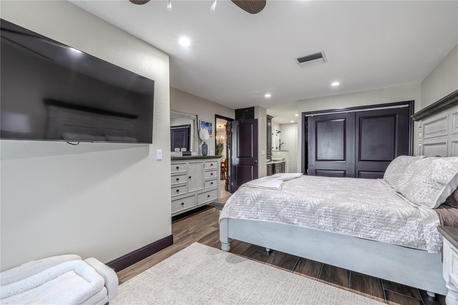 This restful retreat connects seamlessly to the ensuite bathroom, blending modern design with the calm feeling of a private spa.