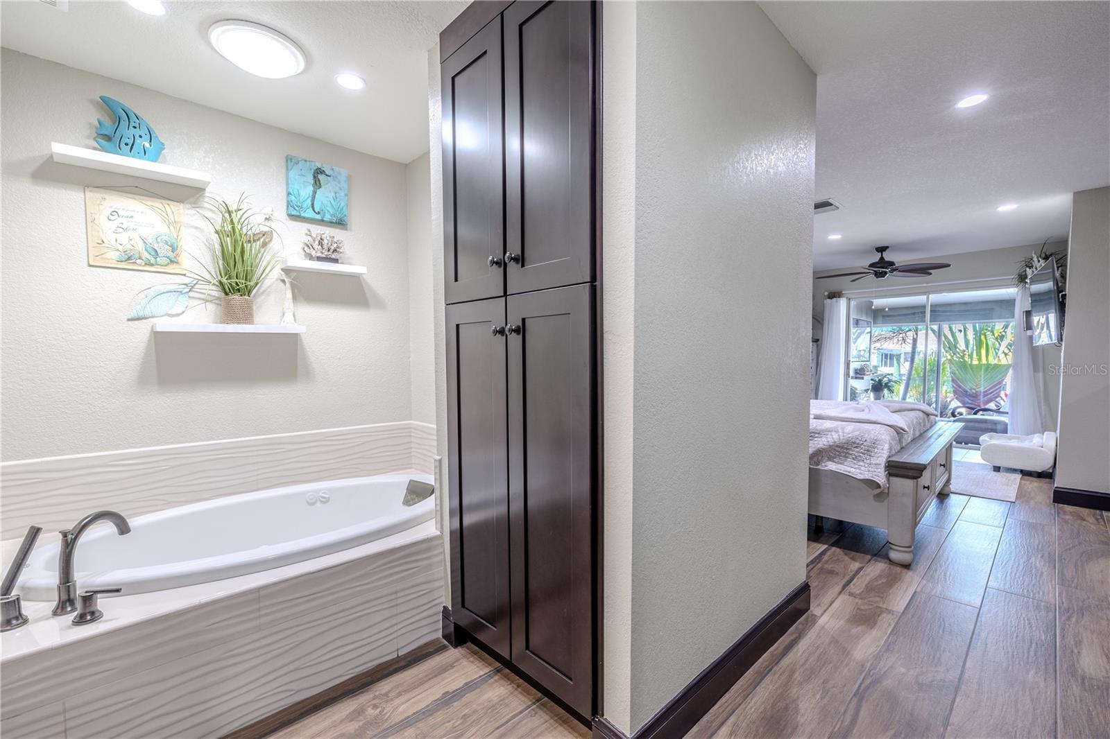 A bright hallway leads from the primary suite toward the main living areas, connecting the private retreat to the open, airy layout of the home.
