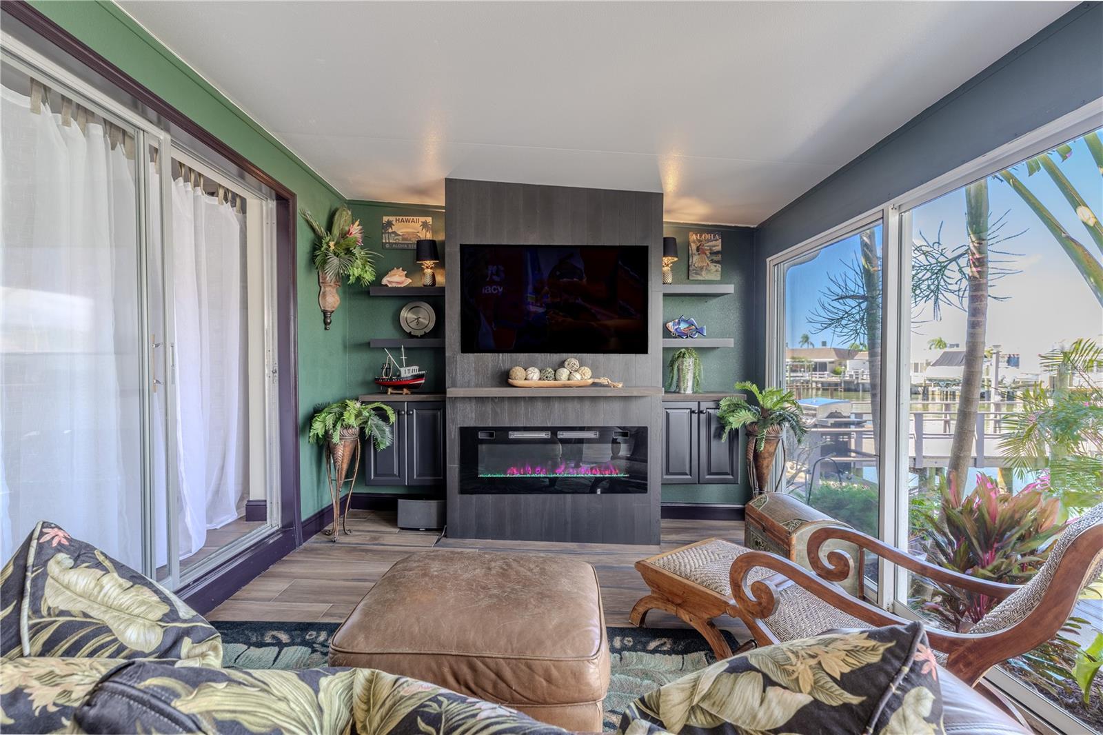 The bonus room offers beautiful water views and built-in shelving that frames a cozy entertainment space with room for a mounted TV.
