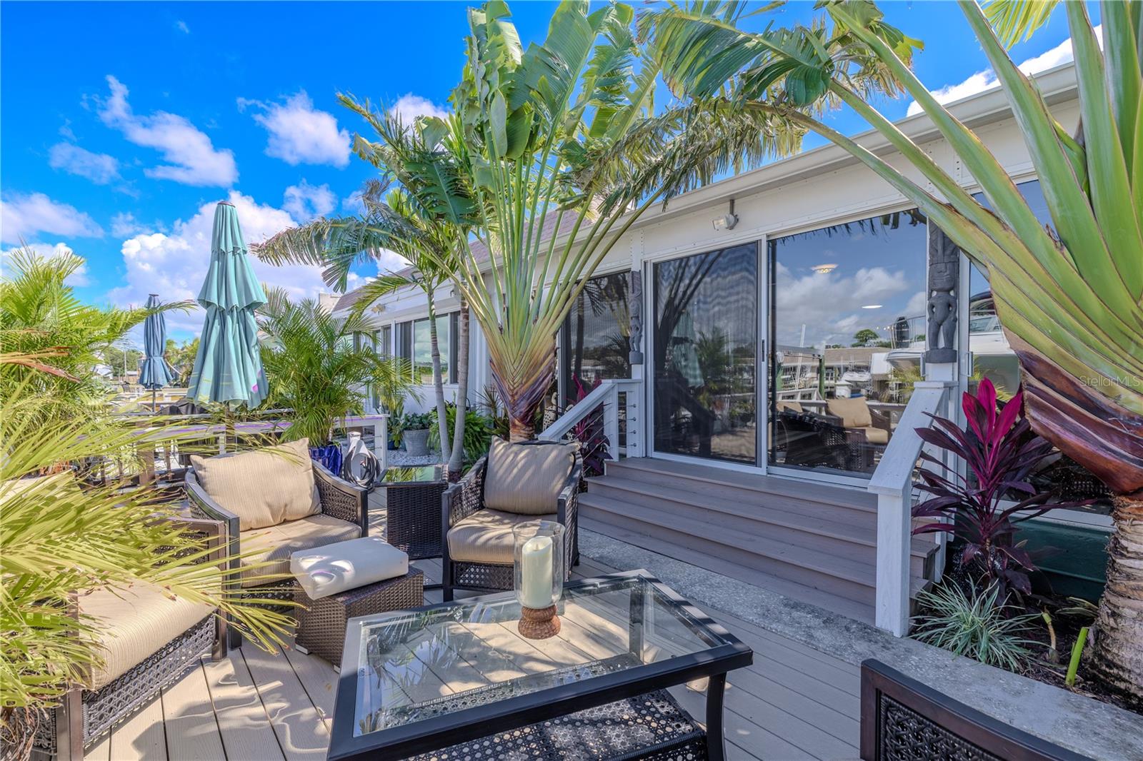 Step outside to the 2022 composite deck, designed for entertaining with tropical planters, lounge seating, and easy access to the dock.