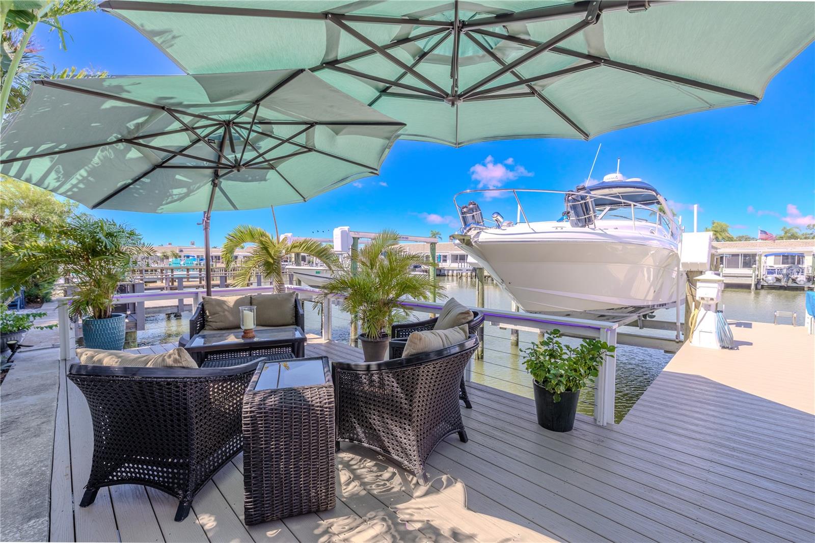 This outdoor oasis overlooks the canal and 16,000-pound boat lift, providing a perfect space to relax and watch the boats drift by.