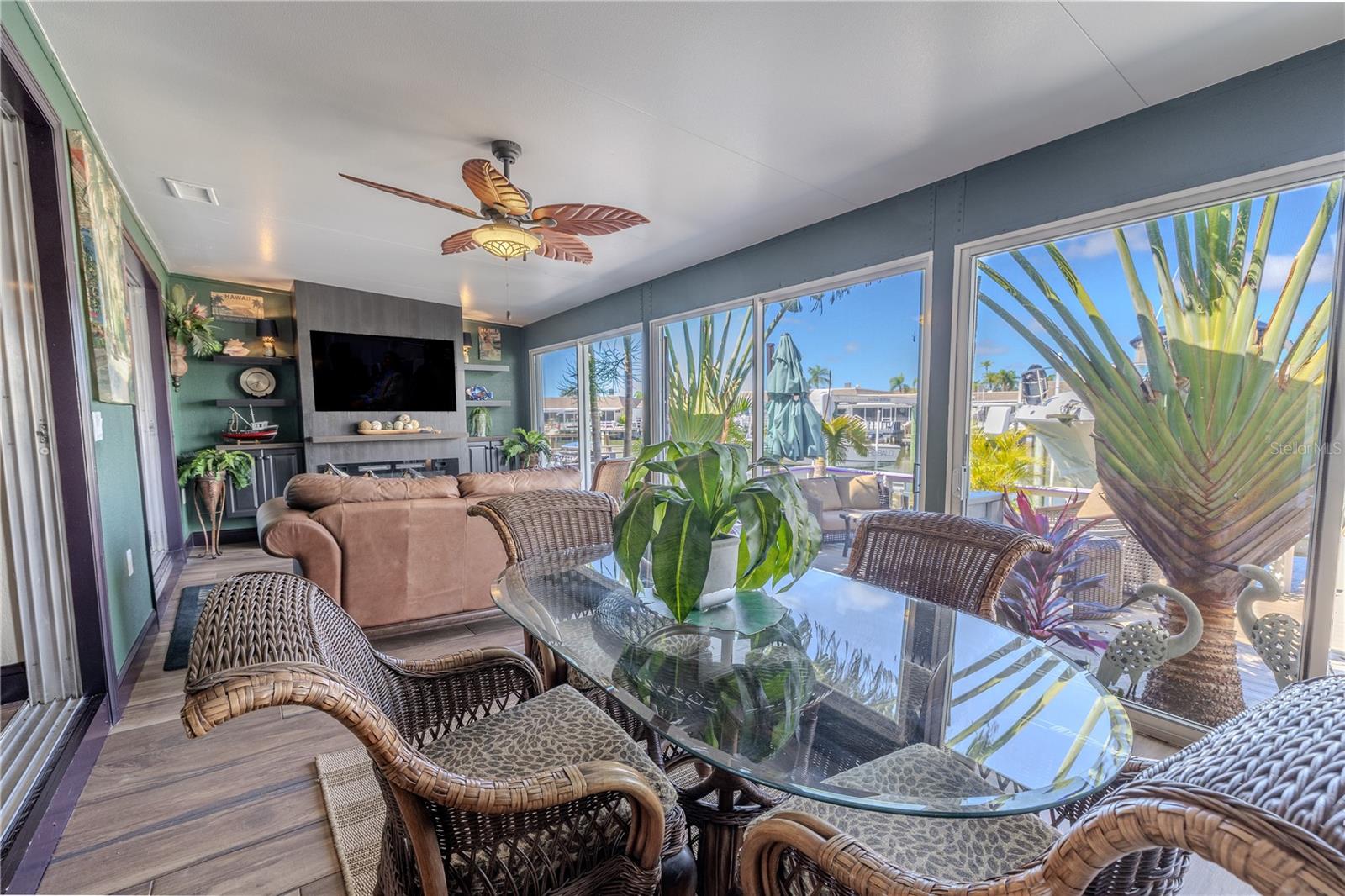 Enjoy the gentle waterfront breeze from the enclosed bonus room, a comfortable spot to unwind with a book or morning coffee.