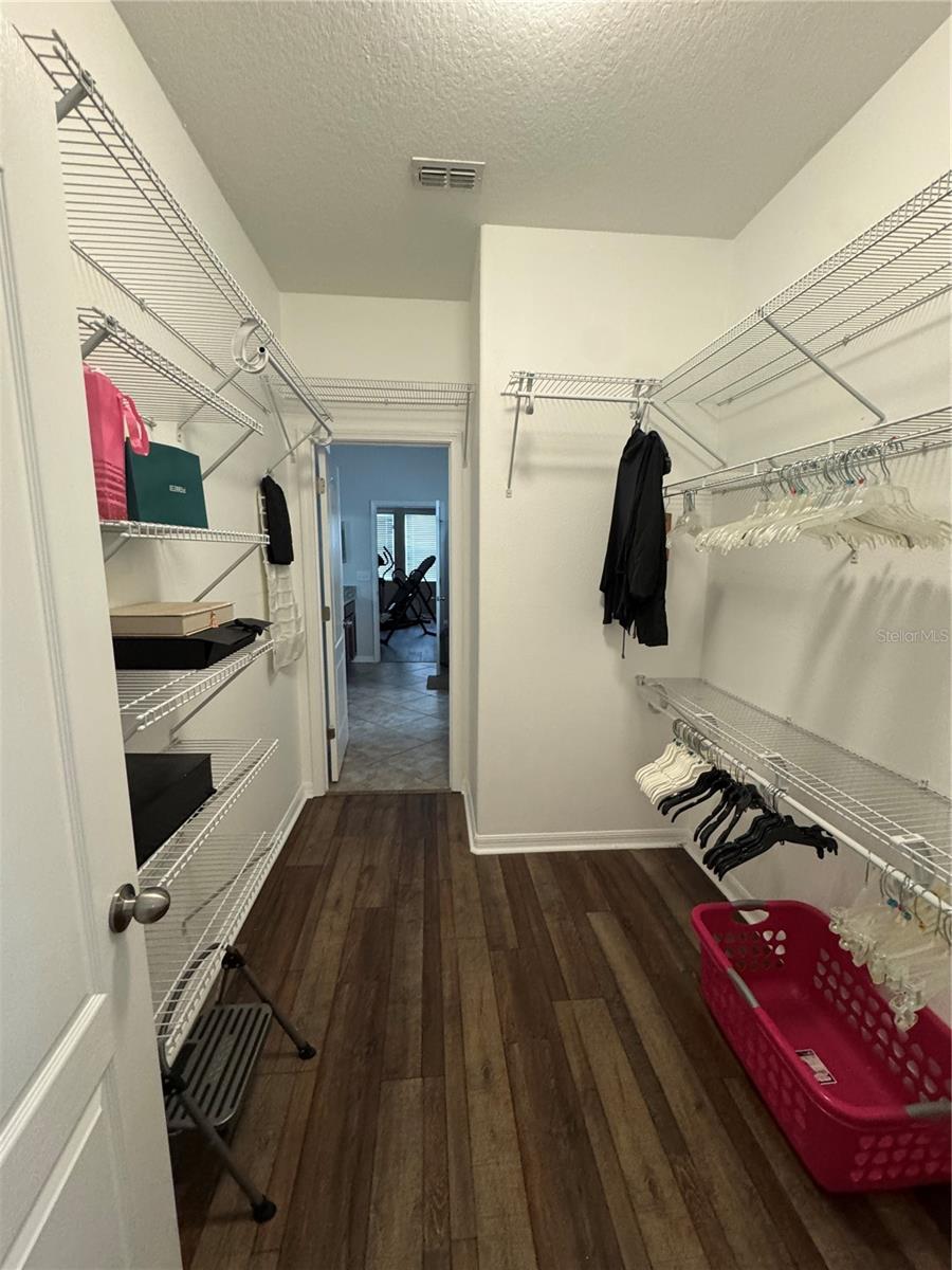Primary bedroom walk-in closet.