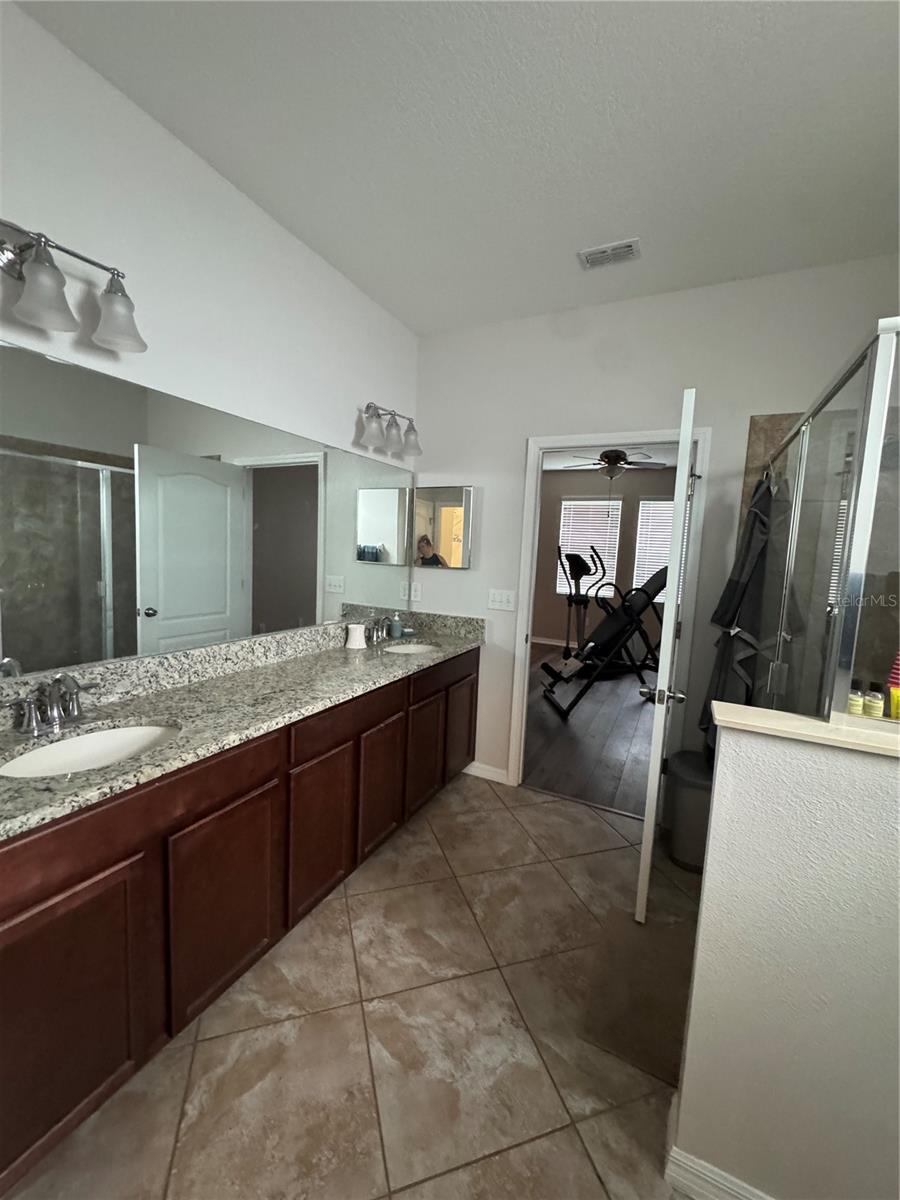 Primary first floor bathroom with his and hers sinks.